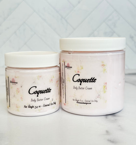 Body butter jars with light pink body cream inside and floral printed label