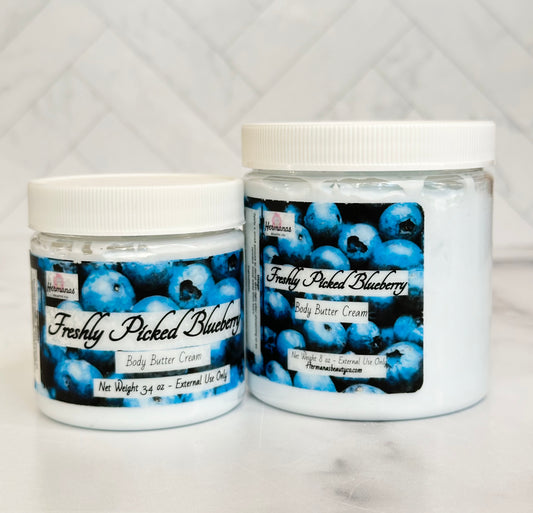Body butter jars in 2 sizes with light blue body cream inside and blue printed label