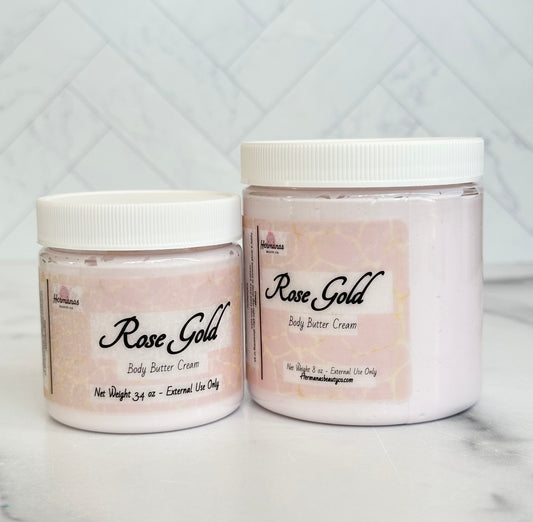 Body butter jars in 2 sizes with body cream inside. Cream is light pink and the jars have a pink printed label