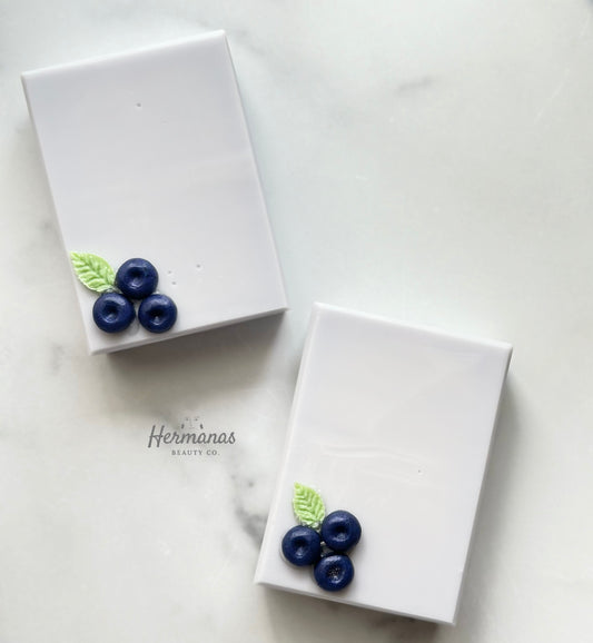 Light blue soap bar with 3 blueberries made of soap and a green leaf