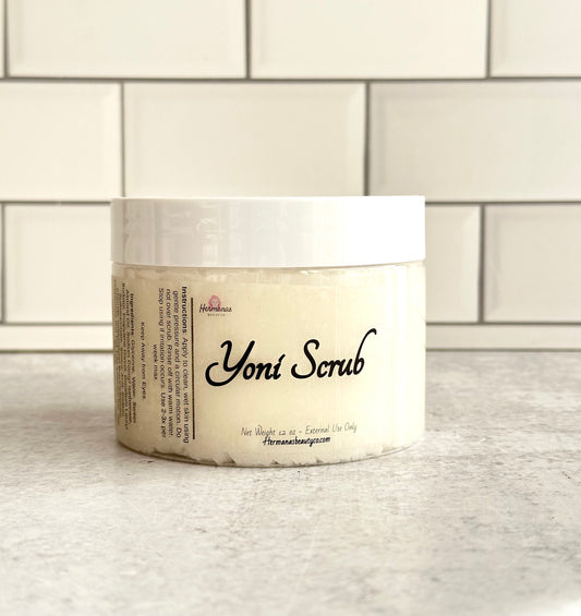 Jar of Yoni scrub, the jar is clear with a white lid, and a label that reads Yoni Scrub