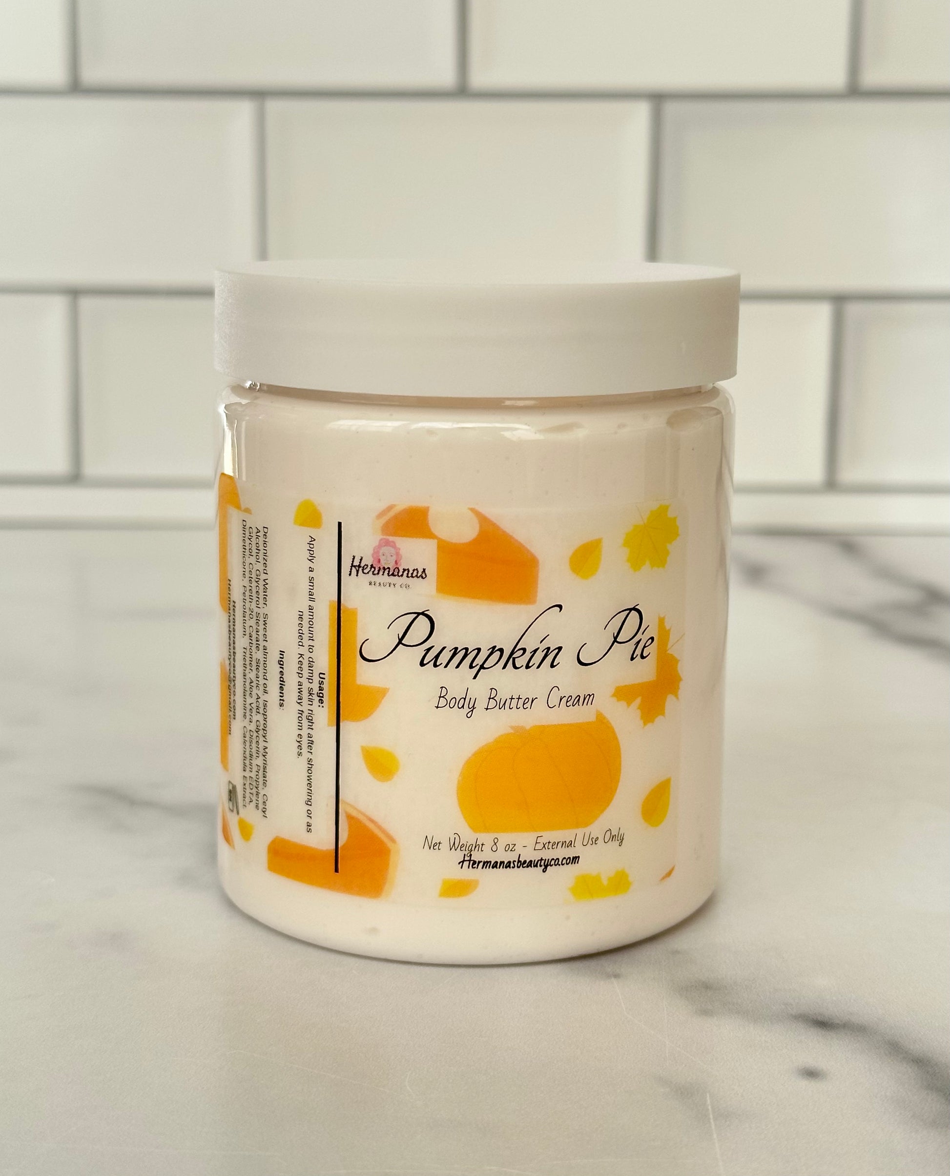 body butter jar scented like a pumpkin pie. label contains cute pumpkin and slices of pie