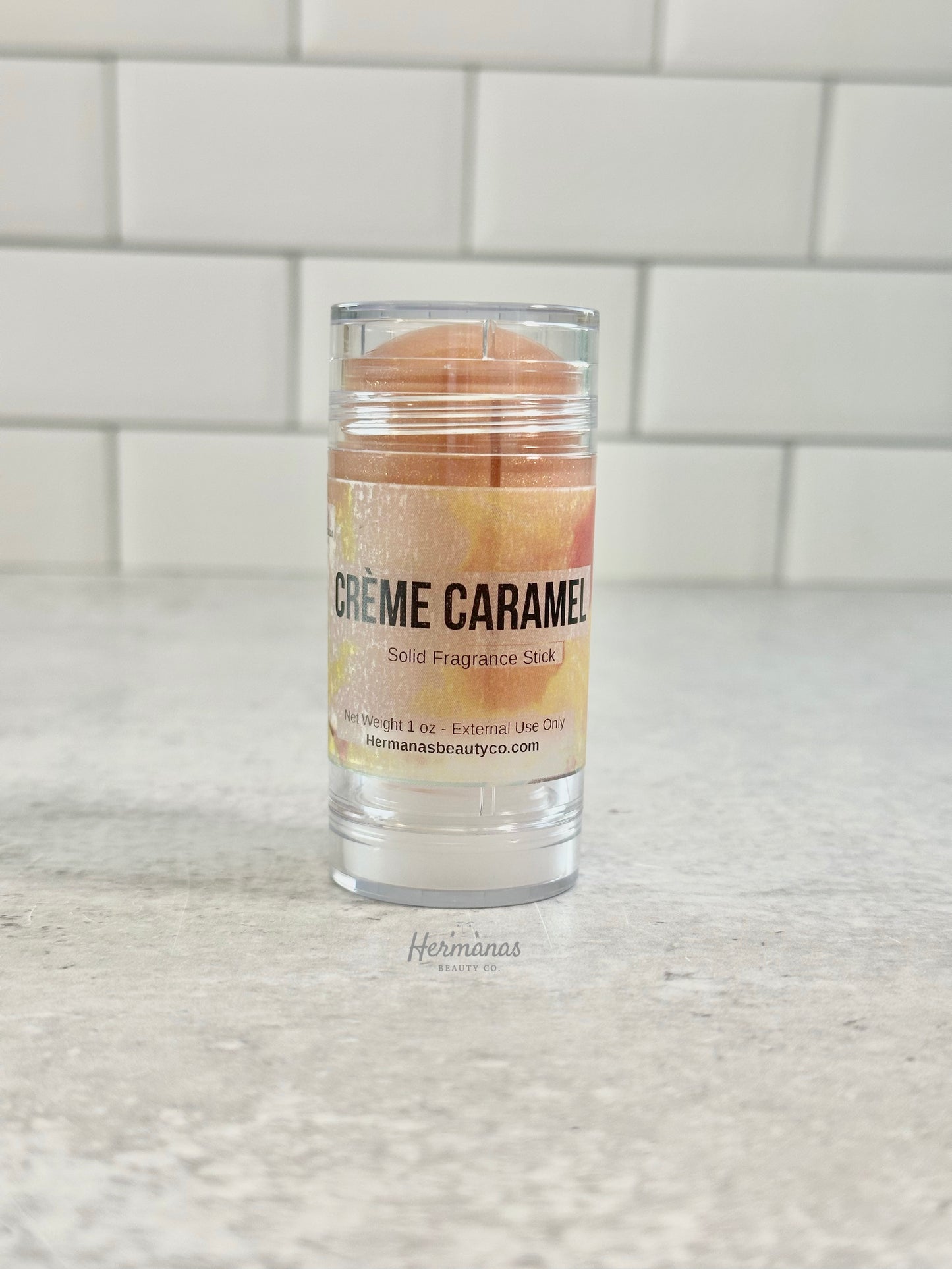 Solid fragrance stick in a clear container labeled 'Cèreme Caramel'.