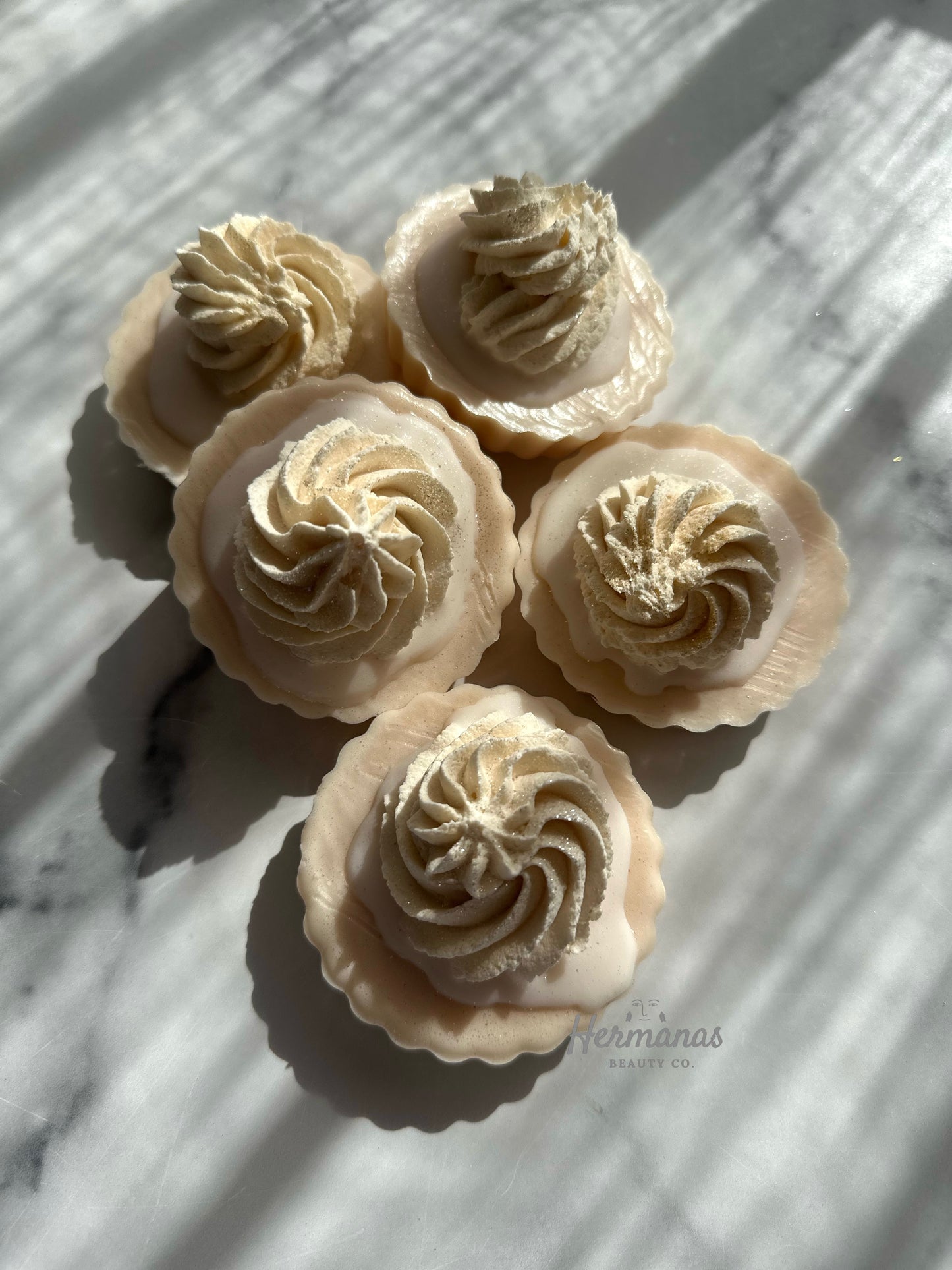 Soap bars shaped like coconut tarts against a white backdrop