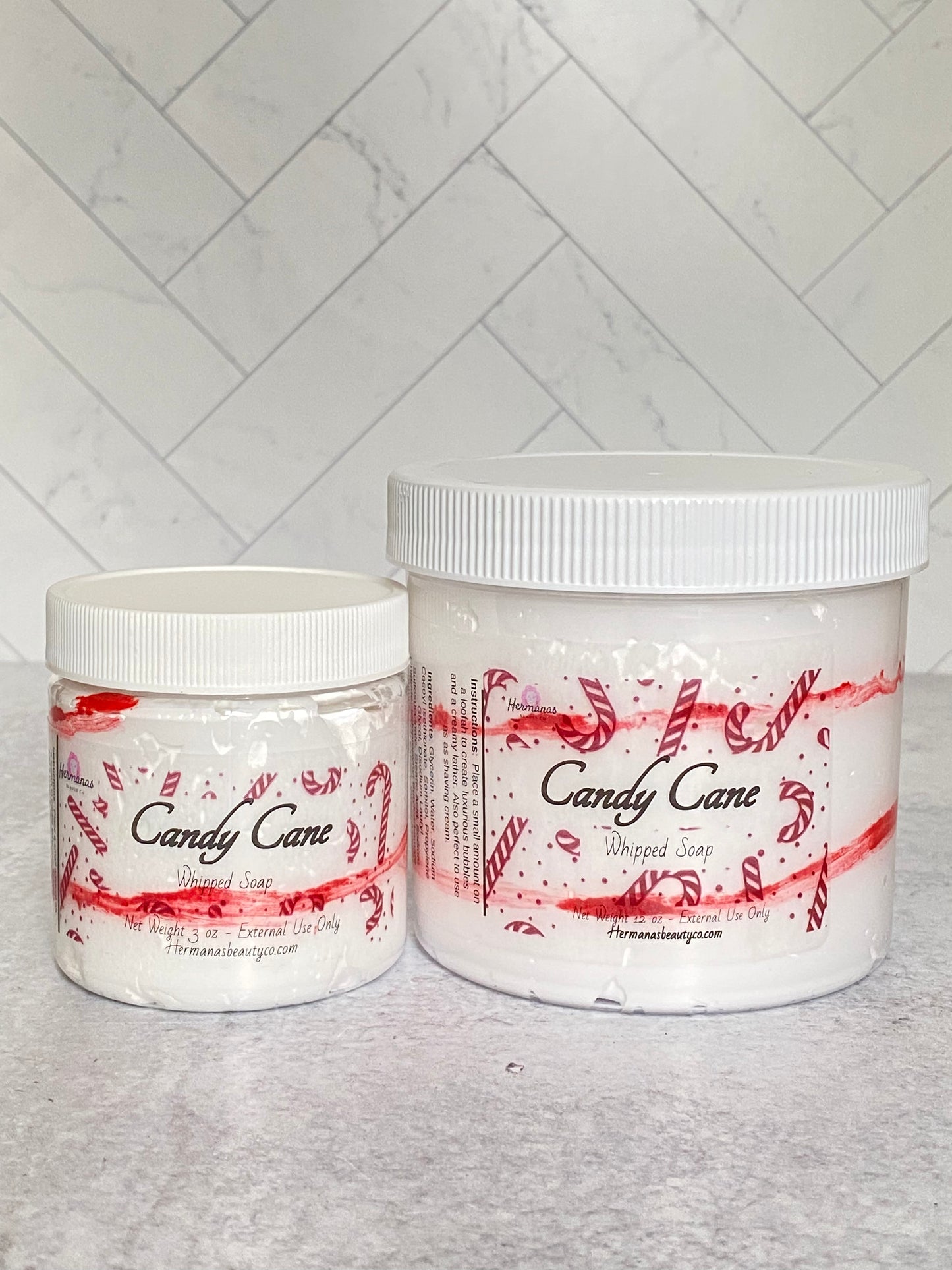 Whipped soap jars filled with whipped soaps and festive red labels featuring candy canes. White top