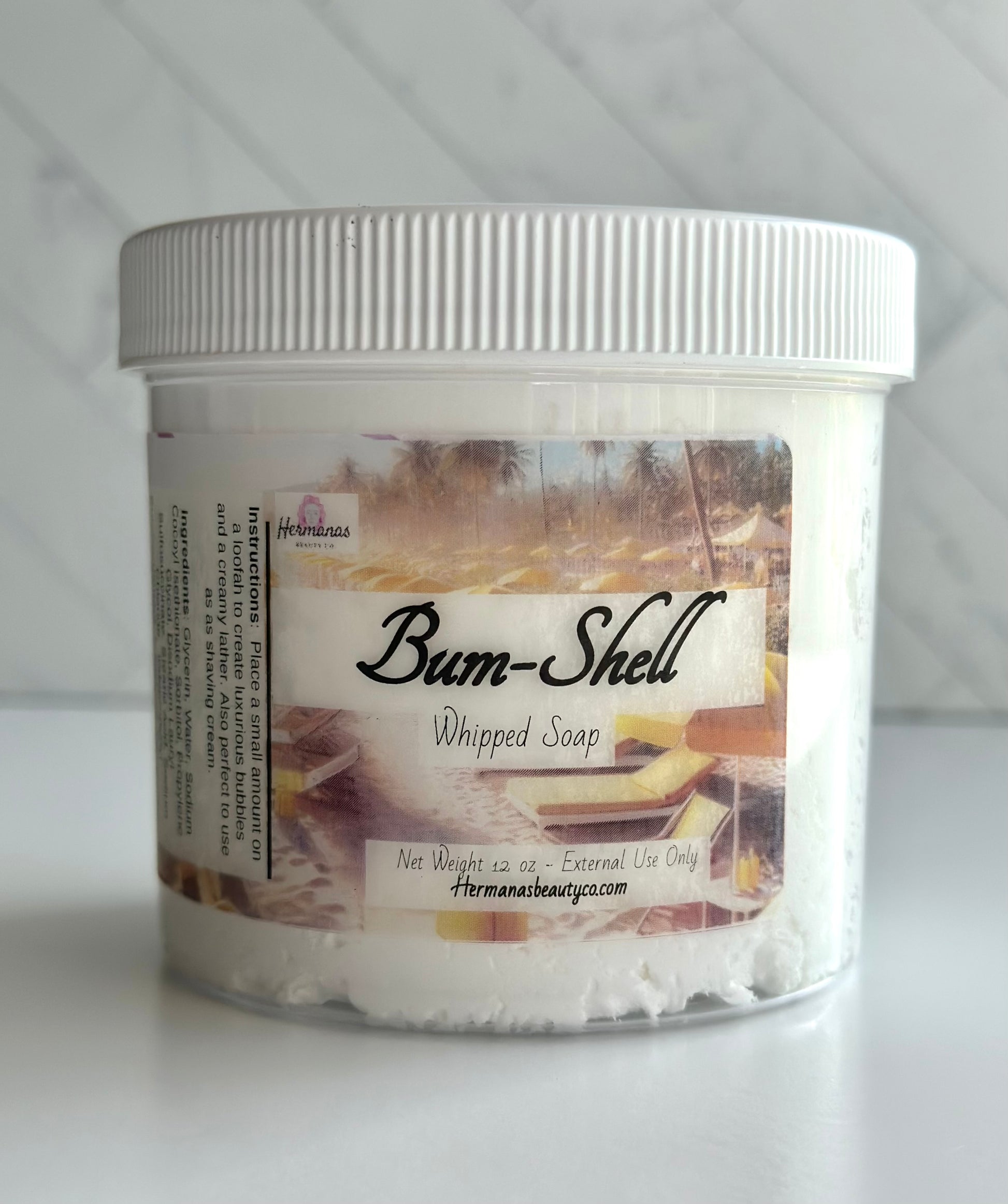 Clear whipped soap jar with a gold and  brown label