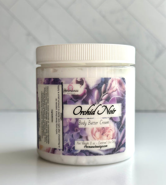Clear body butter jar with a purple label with flowers on it