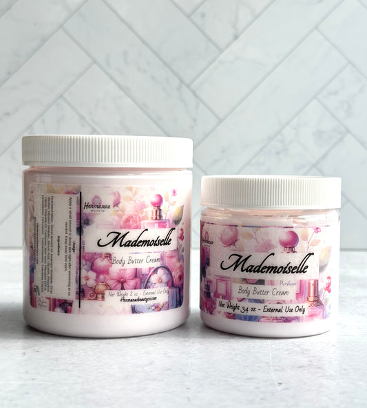 Body butter jars with colorful pink and purple labels. The jars are clear and have white lids