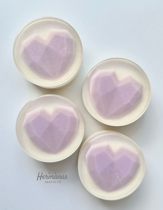 White Round soap bar with a purple heart in the middle. 