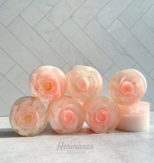 Soap shaped like roses or peonies encased in clear soap. Main colors are pink and white 