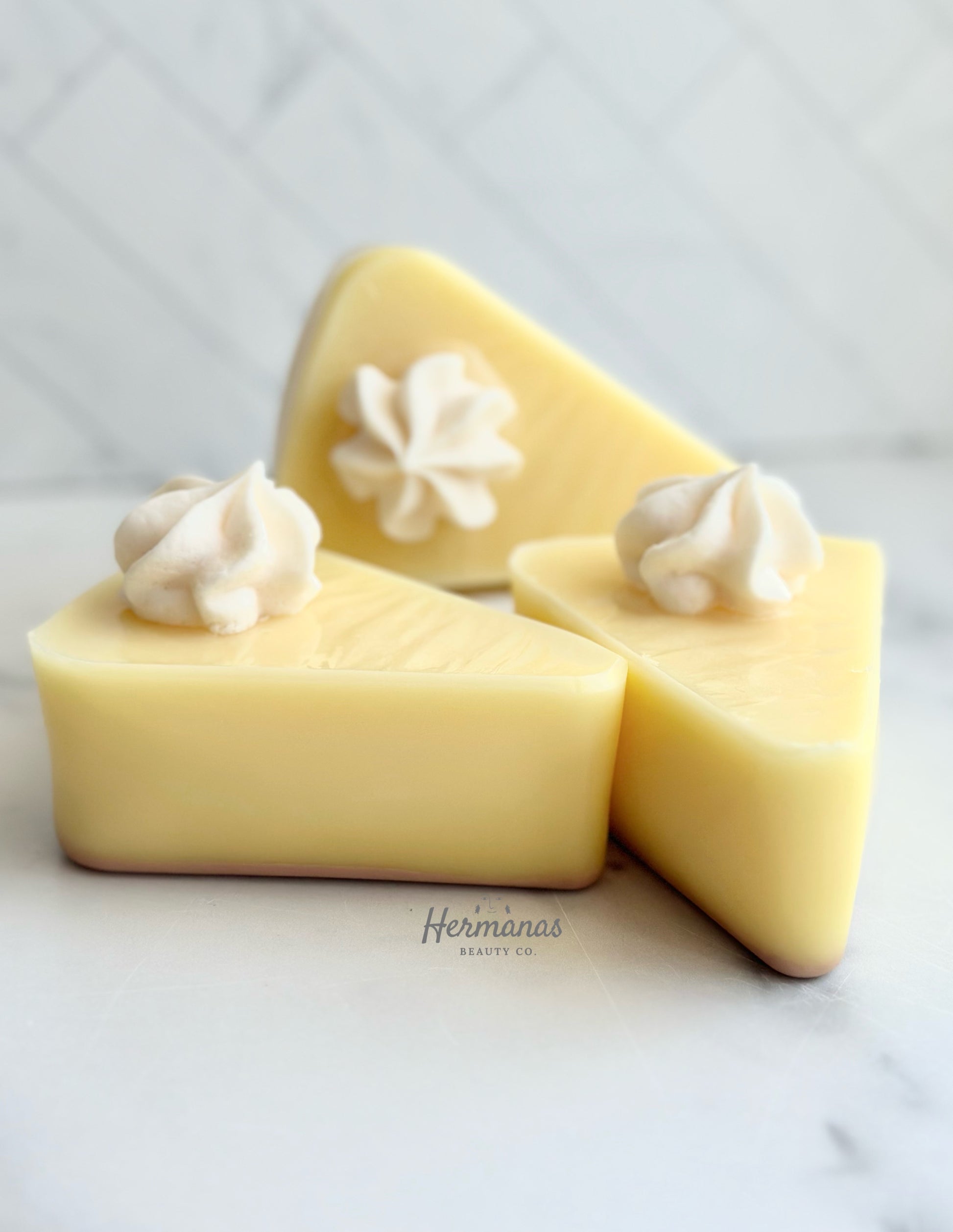 Yellow soap bar shaped like a slice of pie. It had a dollop of white soap on top that resembles whipped cream 