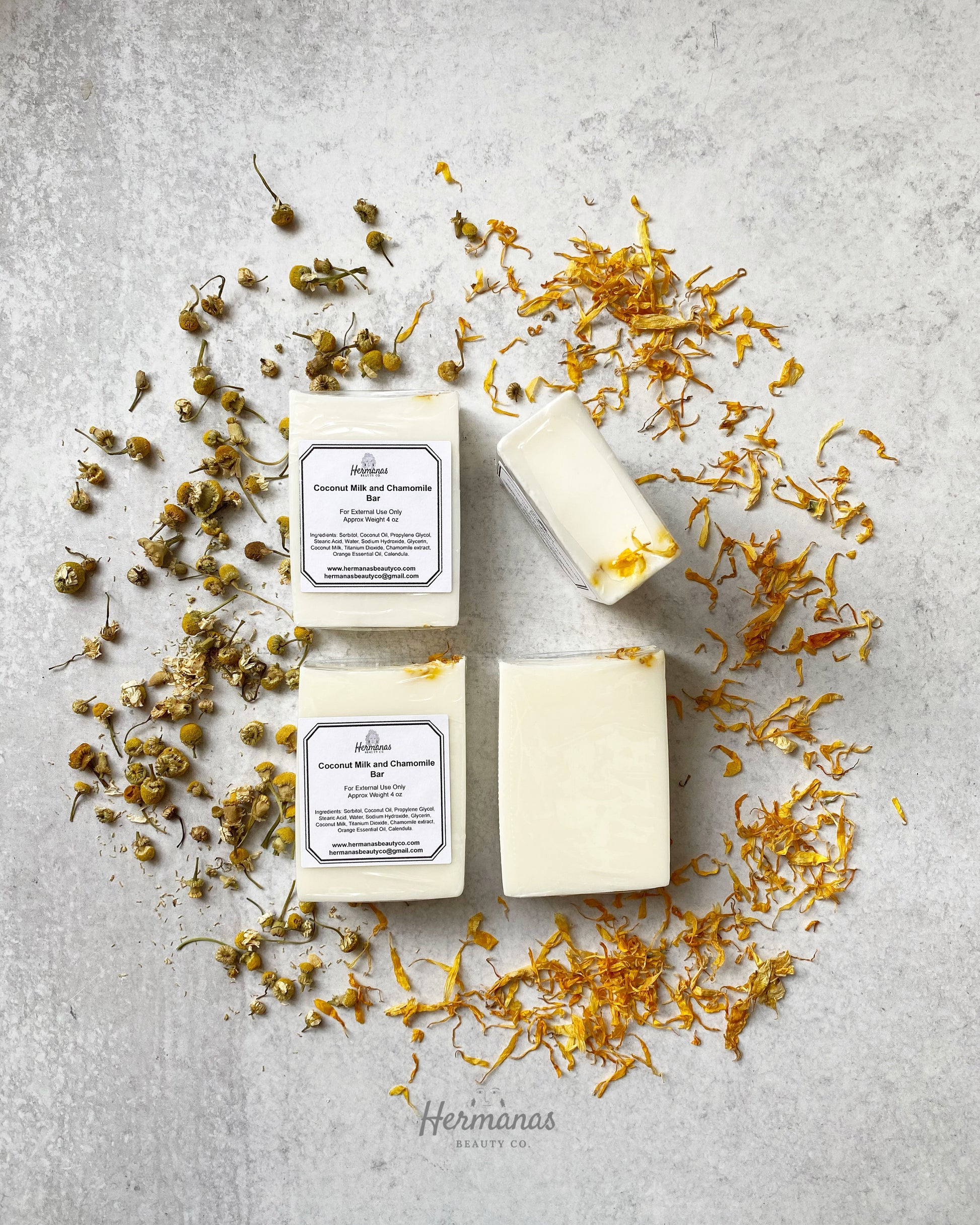 Coconut Milk Chamomile Soap Bar surrounded by chamomile flowers and yellow calendula petals